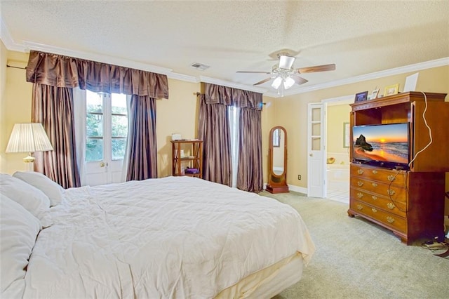 carpeted bedroom featuring a textured ceiling, ceiling fan, and crown molding