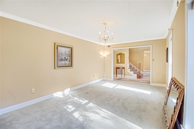 carpeted spare room with ornamental molding and a notable chandelier