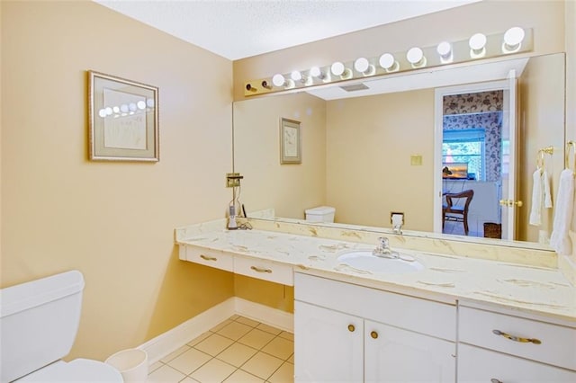 bathroom featuring a textured ceiling, oversized vanity, toilet, and tile flooring