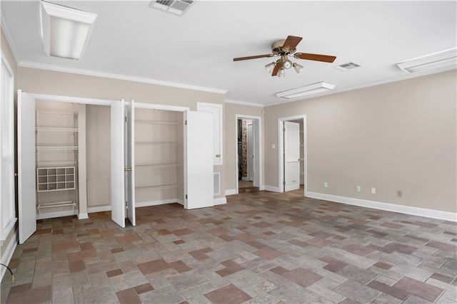 unfurnished bedroom with crown molding, tile floors, ceiling fan, and two closets