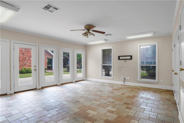 tiled empty room with ornamental molding and ceiling fan