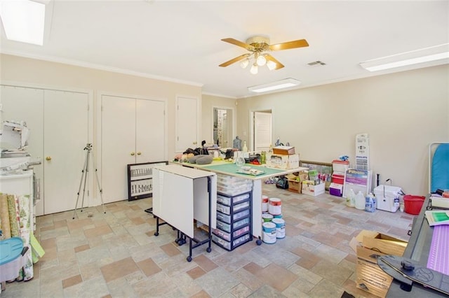 rec room featuring ceiling fan, crown molding, and light tile flooring