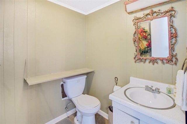 bathroom featuring vanity with extensive cabinet space, toilet, and crown molding