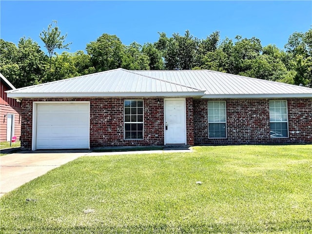 single story home featuring a garage and a front lawn