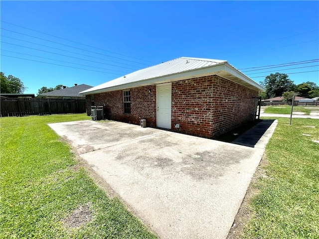 view of home's exterior featuring a patio area and a lawn