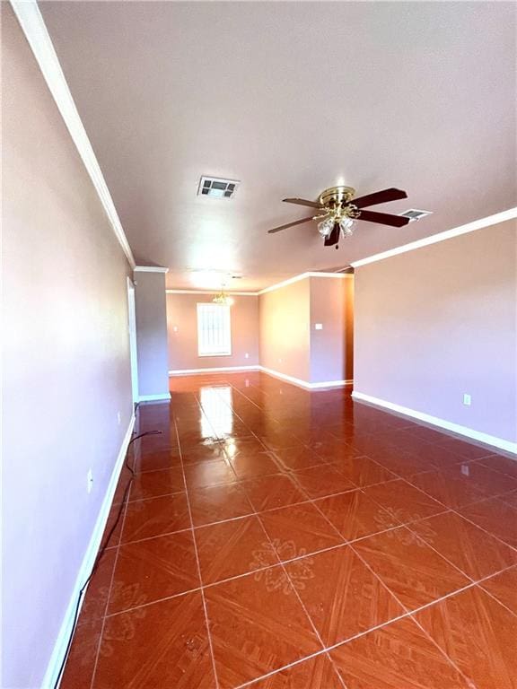 empty room featuring crown molding, dark tile floors, and ceiling fan