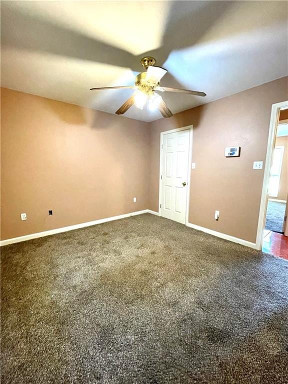 carpeted spare room featuring ceiling fan