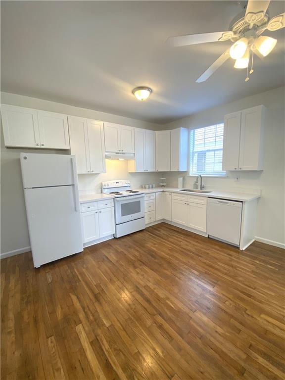 kitchen featuring white cabinets, white appliances, and dark hardwood / wood-style flooring