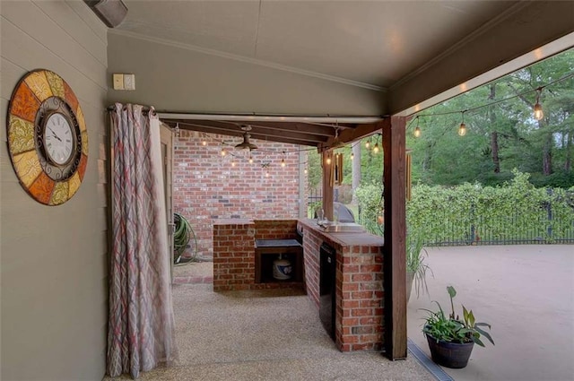 view of patio with area for grilling and ceiling fan