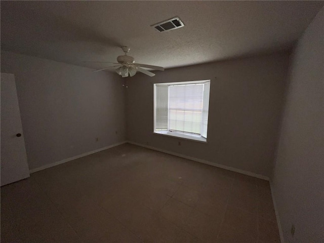 unfurnished room with ceiling fan and tile flooring