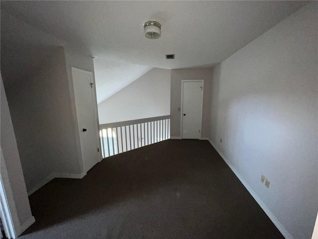 additional living space featuring carpet and lofted ceiling