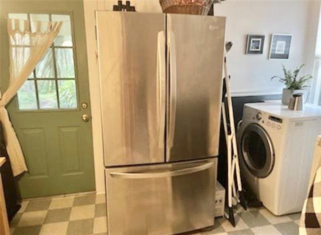 washroom with light tile floors and washer / clothes dryer