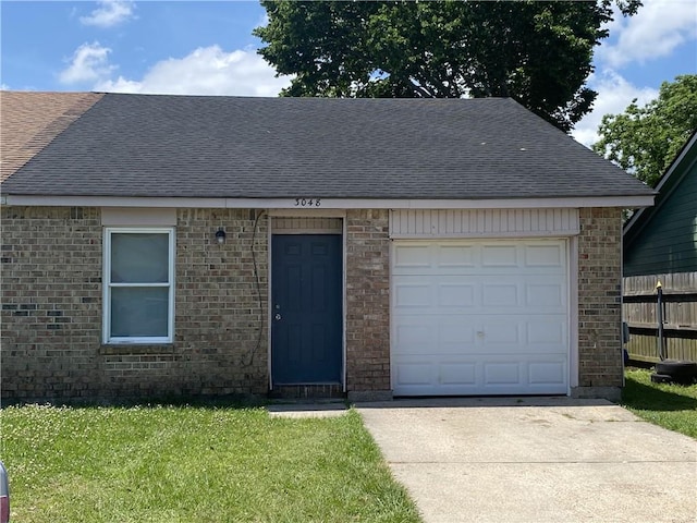 single story home featuring a front yard and a garage