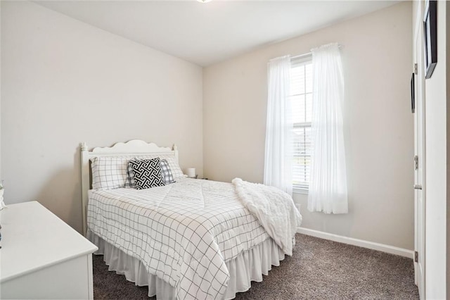 bedroom featuring dark carpet