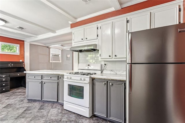 kitchen with white gas range, stainless steel refrigerator, backsplash, wall chimney range hood, and light tile floors