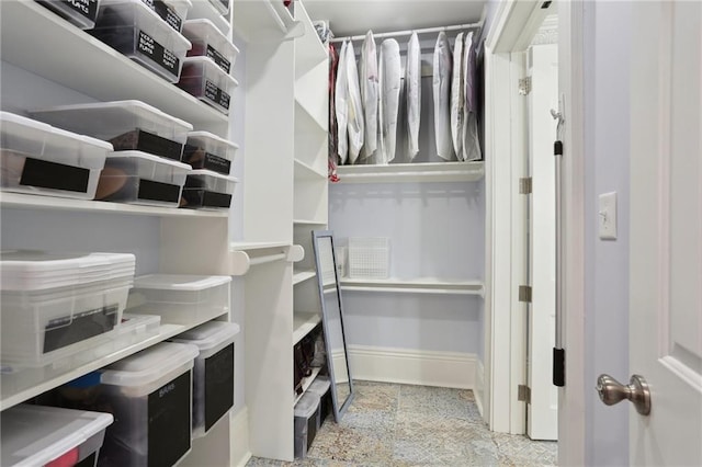 spacious closet with light tile floors