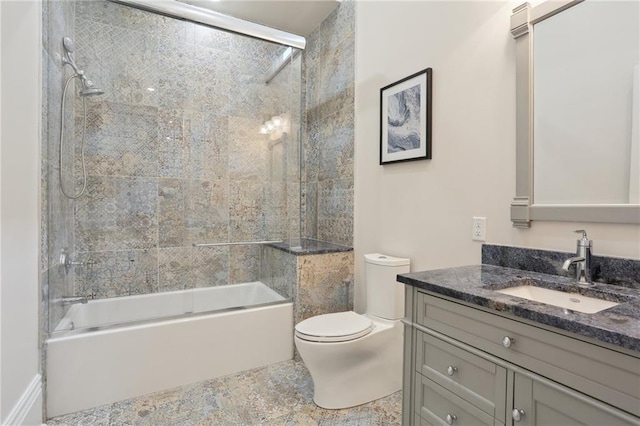 full bathroom with large vanity, toilet, enclosed tub / shower combo, and tile flooring