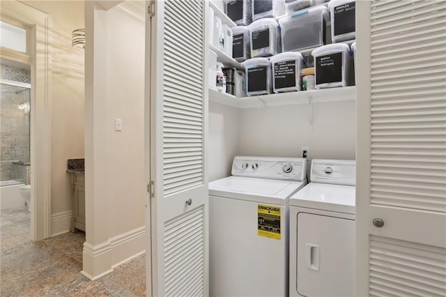 laundry area featuring light tile flooring and washing machine and clothes dryer