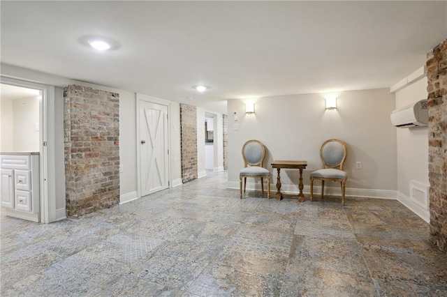 sitting room with an AC wall unit and tile flooring