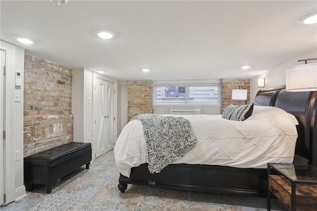 bedroom with a wall mounted air conditioner and brick wall