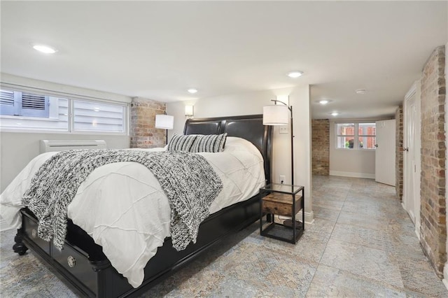 tiled bedroom featuring brick wall