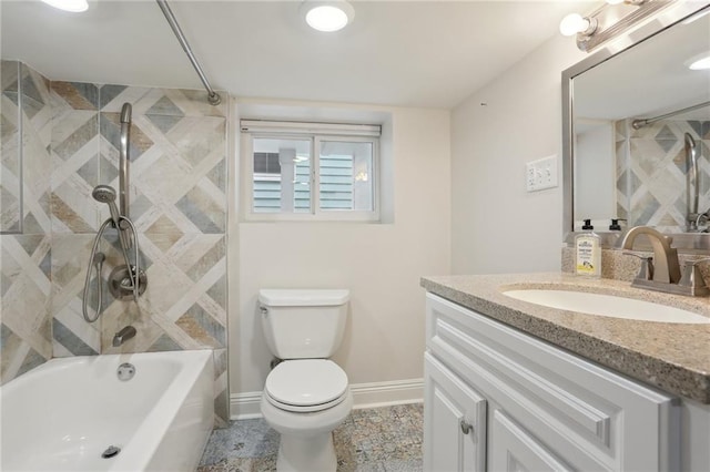 full bathroom featuring tiled shower / bath, toilet, tile floors, and vanity