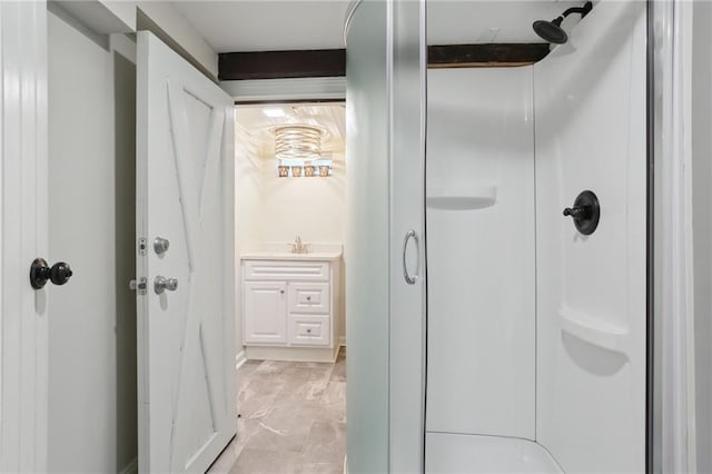 bathroom with tile flooring, walk in shower, and vanity