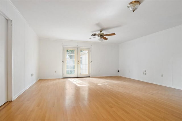 empty room featuring french doors, ceiling fan, and light hardwood / wood-style floors