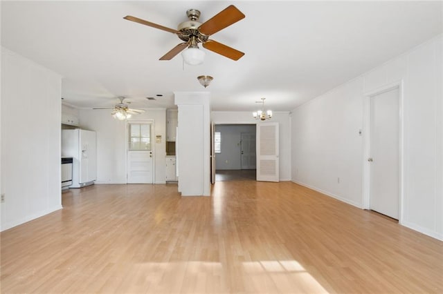 unfurnished living room featuring light hardwood / wood-style floors and ceiling fan with notable chandelier