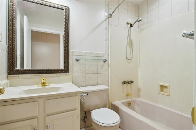 full bathroom with tiled shower / bath combo, oversized vanity, toilet, and tile walls