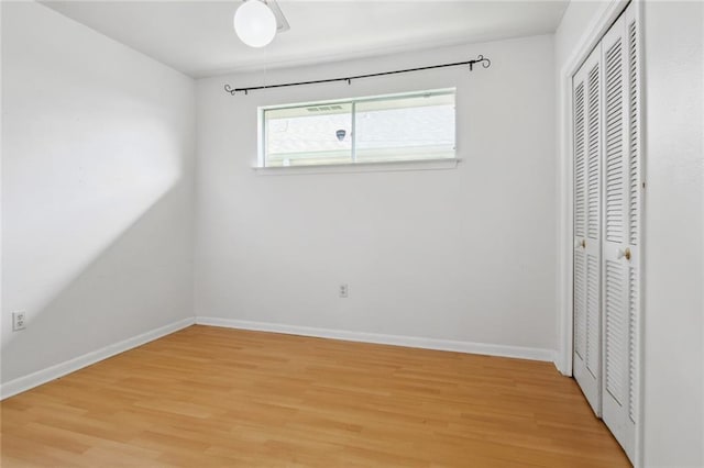 unfurnished bedroom with light hardwood / wood-style floors and a closet