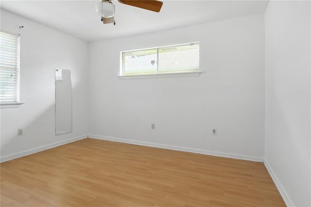 unfurnished room featuring a healthy amount of sunlight, light hardwood / wood-style flooring, and ceiling fan