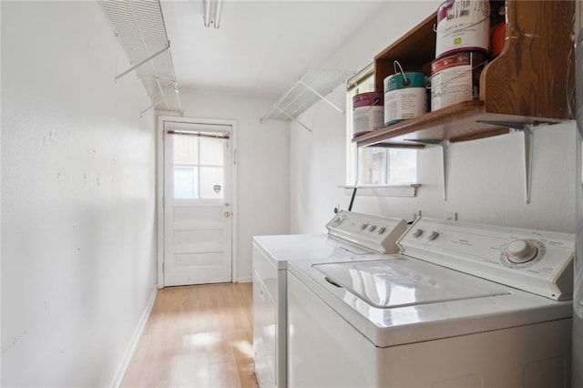 clothes washing area featuring separate washer and dryer and light wood-type flooring