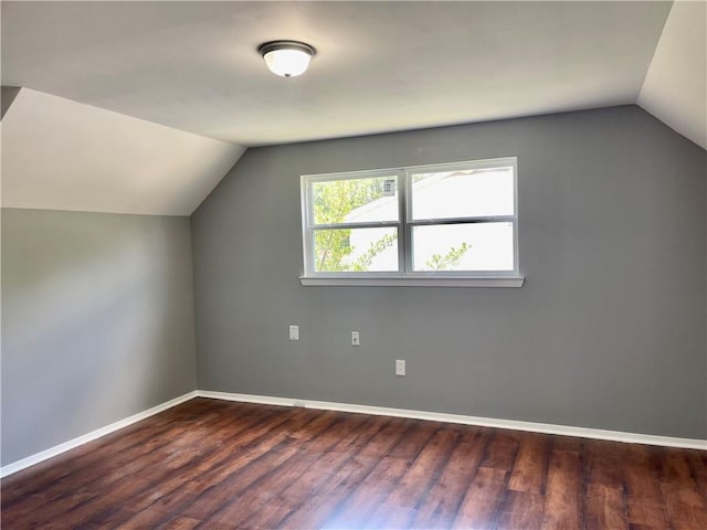 bonus room featuring vaulted ceiling and dark hardwood / wood-style flooring