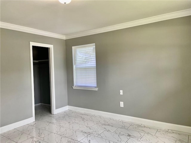 unfurnished bedroom with ornamental molding, a spacious closet, and a closet