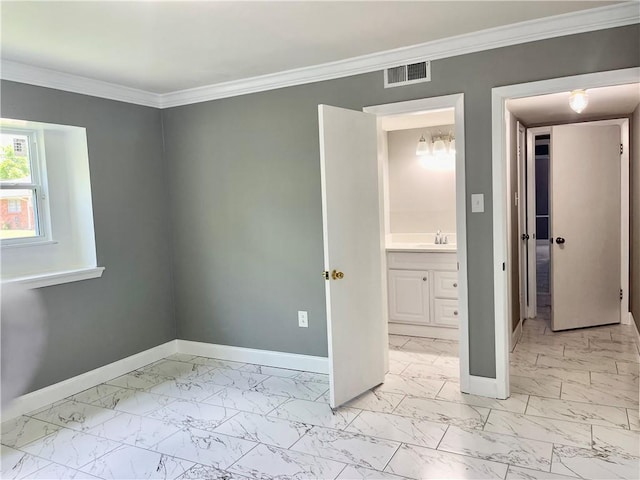 unfurnished bedroom featuring ornamental molding, ensuite bath, and sink