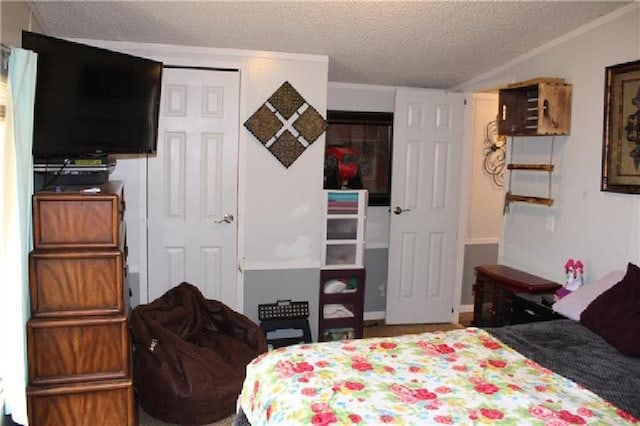 bedroom with a textured ceiling and a closet