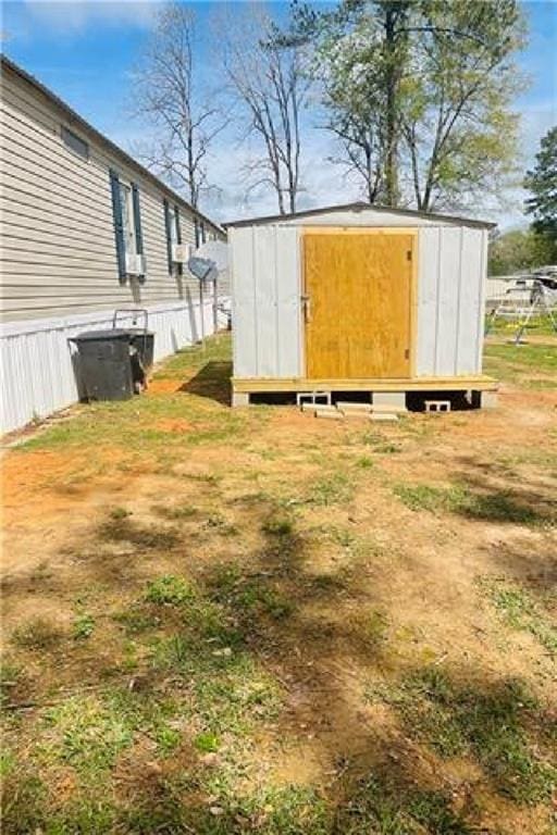 exterior space featuring an outbuilding and a shed