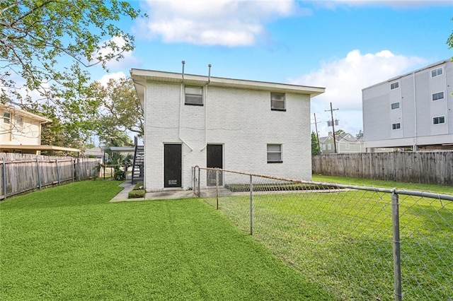 rear view of house with a lawn