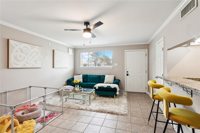 tiled living room featuring ceiling fan and crown molding