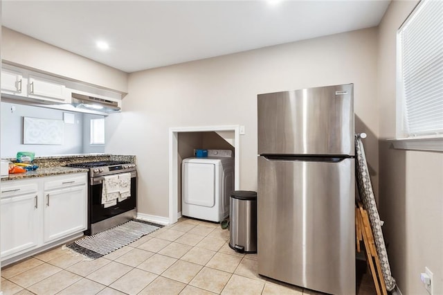 kitchen featuring white cabinets, stainless steel appliances, washer / clothes dryer, and light stone counters