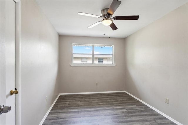 empty room with dark hardwood / wood-style floors and ceiling fan