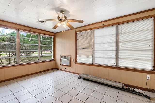 unfurnished sunroom with ceiling fan and a wall mounted AC