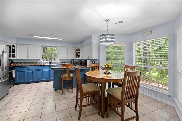 dining area with sink and light tile patterned flooring