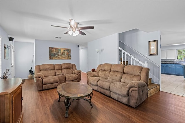 living room featuring ceiling fan and light wood-type flooring