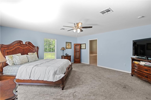 carpeted bedroom featuring ceiling fan and ensuite bath