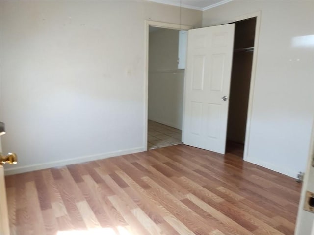 unfurnished bedroom featuring a closet and hardwood / wood-style floors