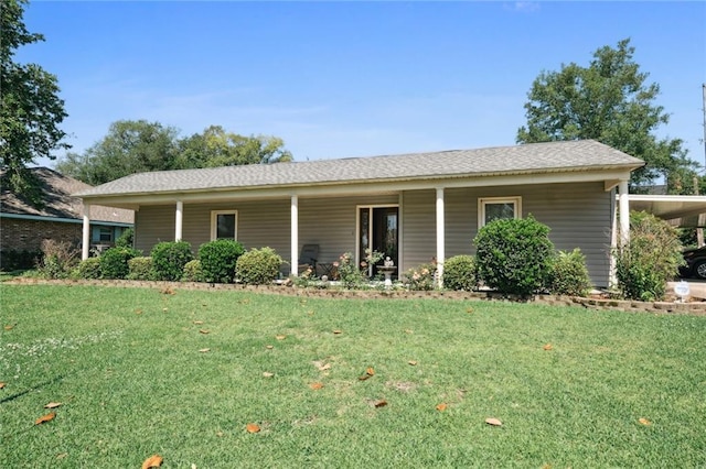 view of front of house featuring a front lawn and a carport