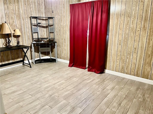 interior space featuring wood walls and light hardwood / wood-style floors