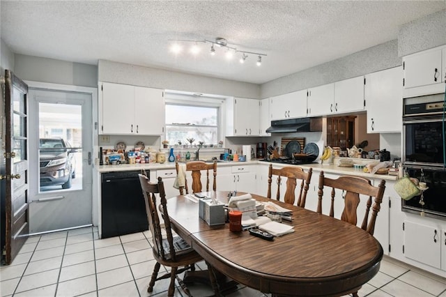 kitchen featuring a textured ceiling, white cabinetry, a wealth of natural light, and black appliances